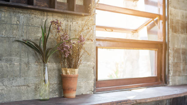 Flower vase place near a window.