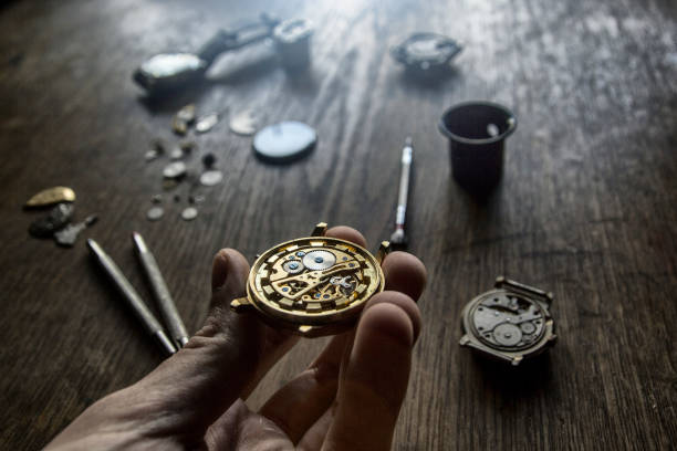 istock A watch maker is repairing a vintage automatic watch. 898945724