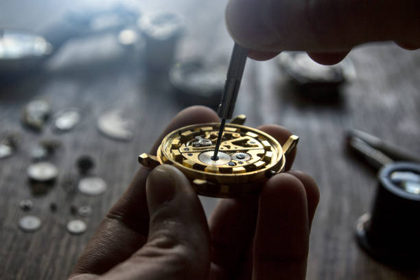 istock A watch maker is repairing a vintage automatic watch. 898945758
