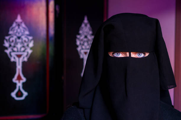 istock Arab woman with face covered with black niqab 898945856