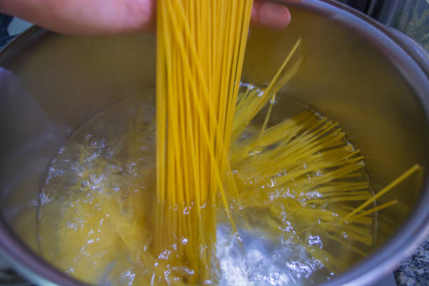 istock Cooking pasta in boiled water 898946632