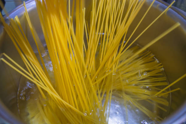 istock Cooking pasta in boiled water 898946634