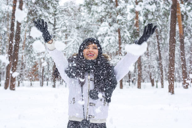 istock Beautiful young brunette having fun in the winter forest 898947602