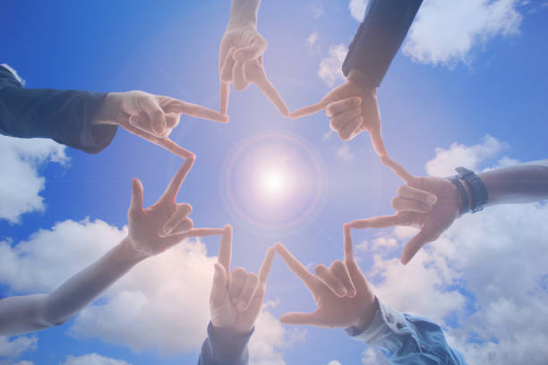 Meeting teamwork concept, Friendship group with hands showing unity on blue sky background, Symbol for love