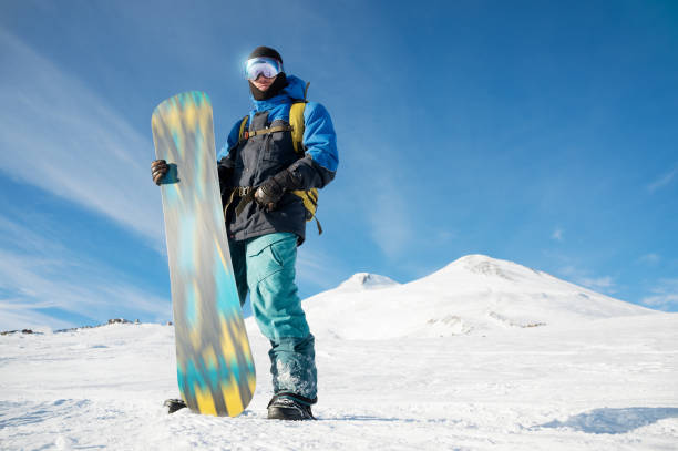 istock A professional snowboarder stands with his snowboard 898950090
