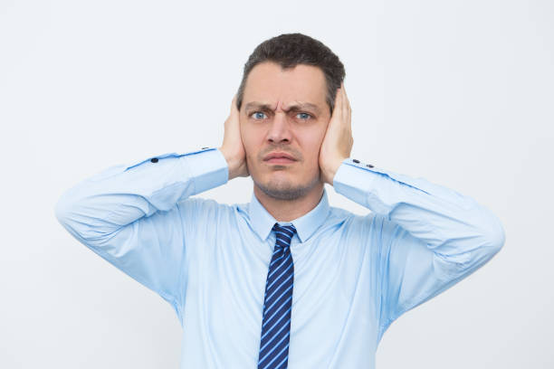istock Stressed young businessman holding head in hands 898951474