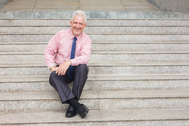 istock Relaxed Entrepreneur Sitting on Stairs Outdoors 898955154