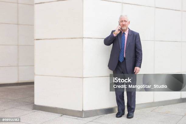 Serious Business Man Talking On Phone Outdoors Stock Photo - Download Image Now - Adult, Adults Only, Biological Cell