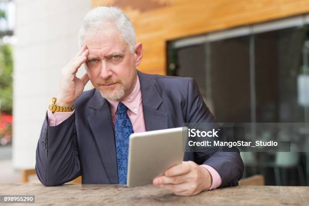 Tensed Business Man With Tablet In Street Cafe Stock Photo - Download Image Now - Adult, Adults Only, Blurred Motion