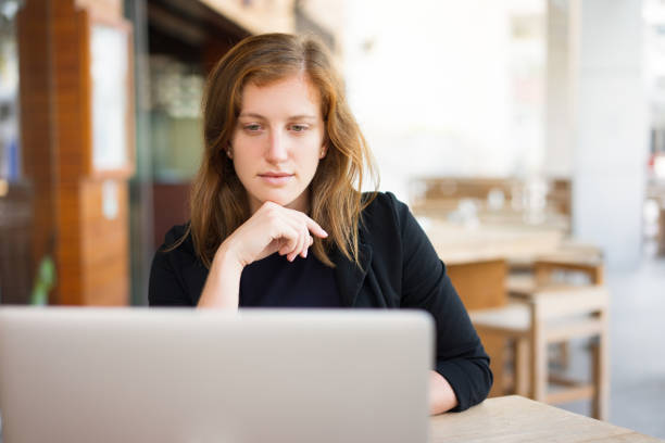 istock Concentrated Woman Working on Laptop at Cafe 898958182