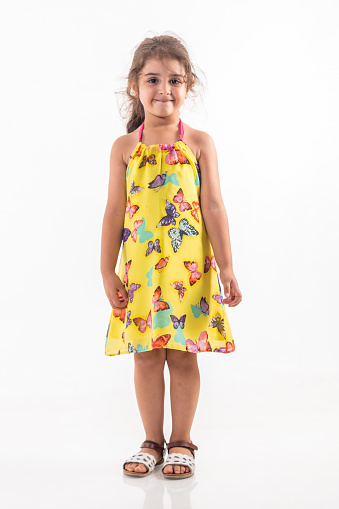 little girl with yellow dress over white background