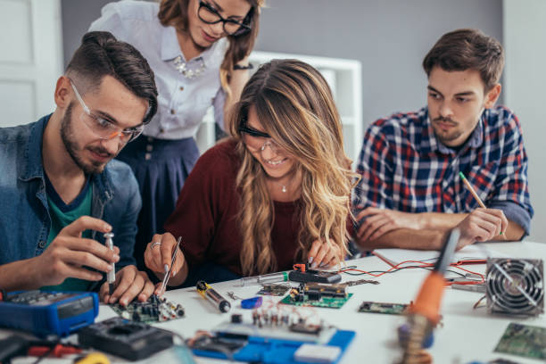 istock Group of young students engineers working together 898958338