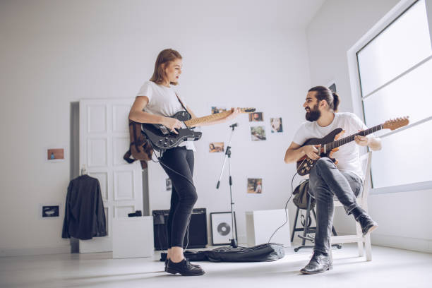 istock Couple playing guitar together 898959208