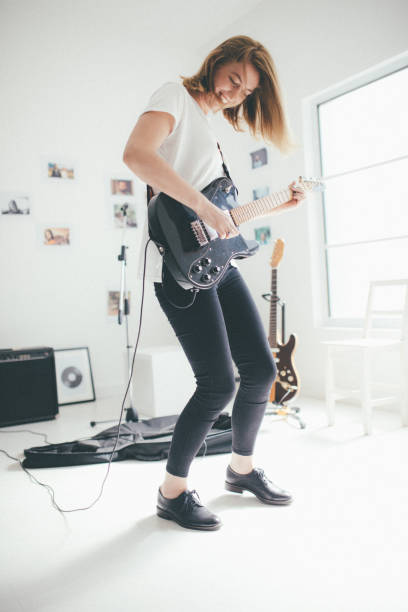 istock Woman playing elctric guitar 898959388