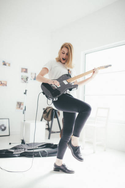 istock Pretty woman playing elctric guitar 898959430