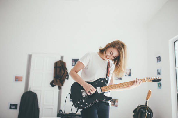 istock Beautiful woman playing elctric guitar 898962302