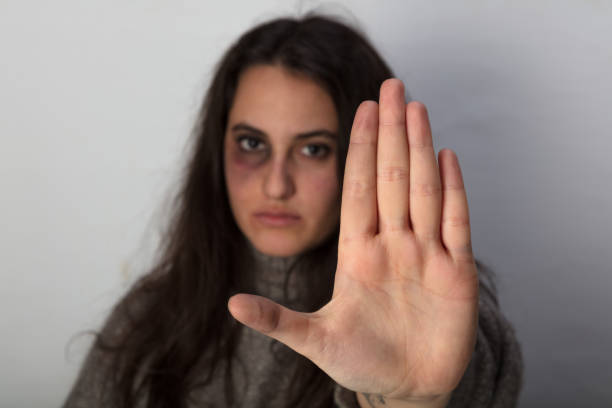 Abused woman calling a halt to domestic violence stock photo
