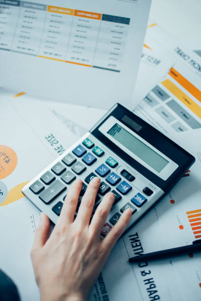 istock Closeup of Marketing Expert Hand Using Calculator 898962580