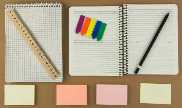 Photo of Modern samples of stationery, notebooks, stickers and pencils