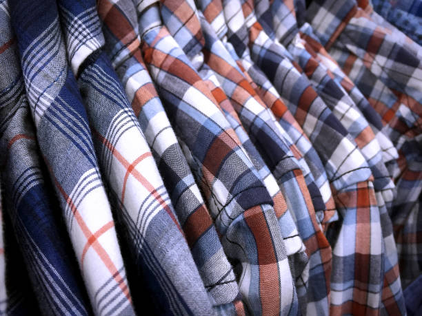 istock Patterned Shirts for Men Hanging on Rack in Clothing Store 898963532