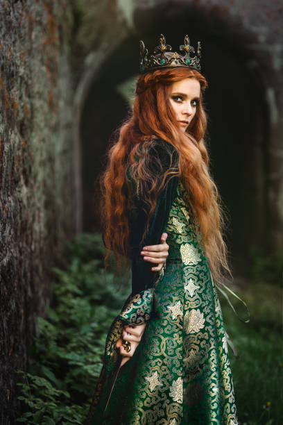 Ginger queen near the castle Red-haired woman in a green medieval dress near the castle renaissance dress stock pictures, royalty-free photos & images