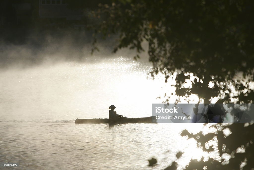 kayaking Kayaking on the lake in the early morning. Bright Stock Photo