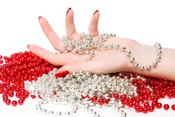 Woman hand with red and silver glassbeads.