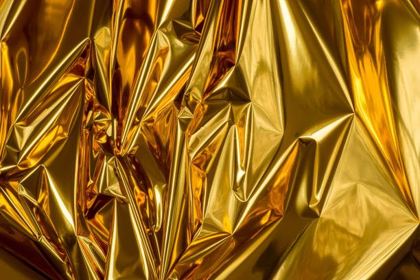 golden folded metallic foil abstract bacgkground stock photo