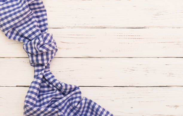 istock Blue knotted tablecloth on white wooden table background 898971460