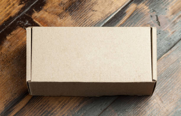istock Cardboard box on a wooden background 898979840