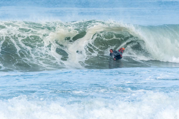 istock Bodyboarder surfing ocean wave 898980306
