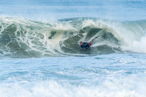 istock Bodyboarder surfing ocean wave 898980328