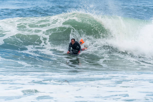 istock Bodyboarder surfing ocean wave 898980502