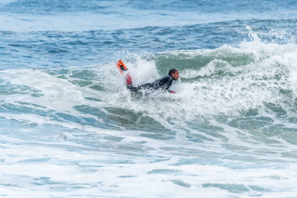 istock Bodyboarder surfing ocean wave 898980614