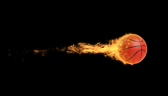 Chinese basketball ball in flames over black background. Horizontal composition with copy space.