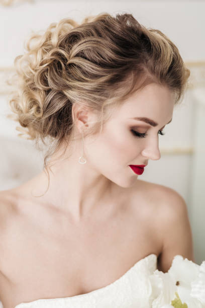 Sensual portrait of bride blonde in a white interior