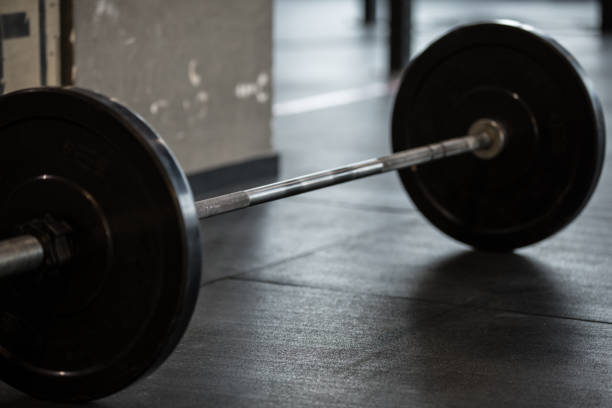istock Barbell in gym on floor 898987930
