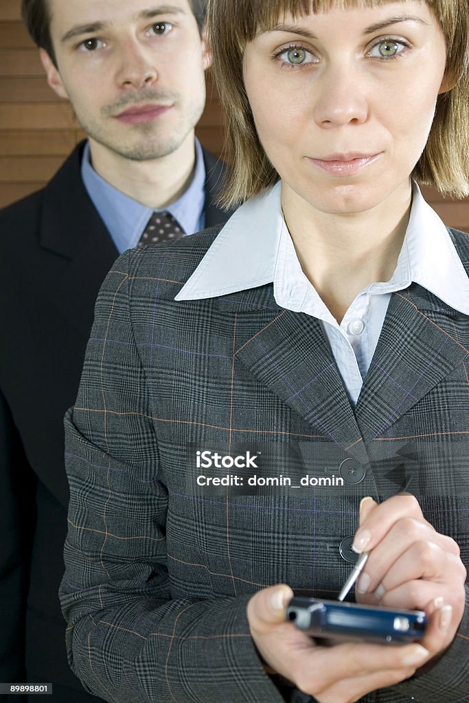 Business Partners Young Businesswoman holding PDA/MDA. Blond Hair Stock Photo