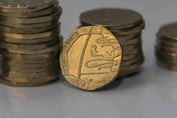 istock Stacks of different British coins on a white background. 898988704