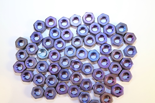 Nuts for bolts and screws of blue-blue color on a white background