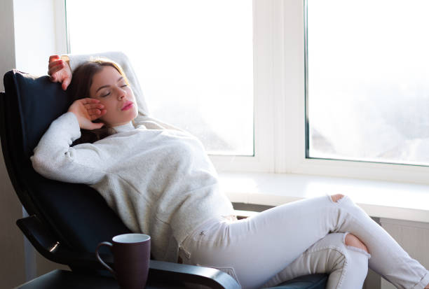 istock Woman sitting by the window 898992050
