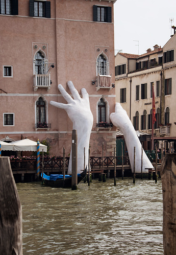 View of a monumental installation sculpture (called support) by Italian artist Lorenzo Quinn for the 2017 Venice Art Biennale to raise awareness about global warming in Venice.