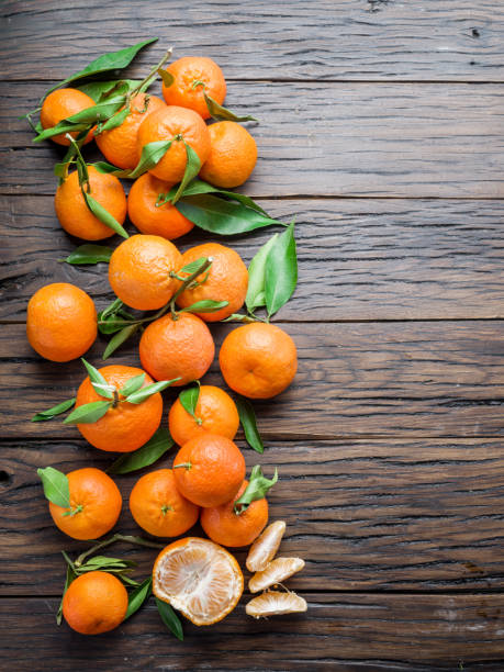 istock Ripe tangerines on wooden table. 898992234