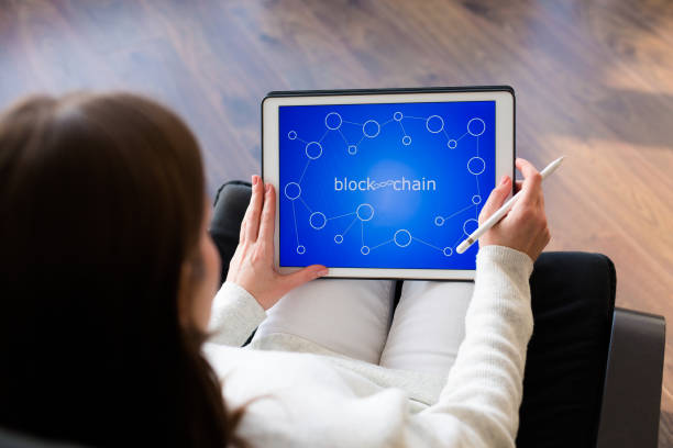 istock Woman holding a tablet with cryptocurrency logos 898994404