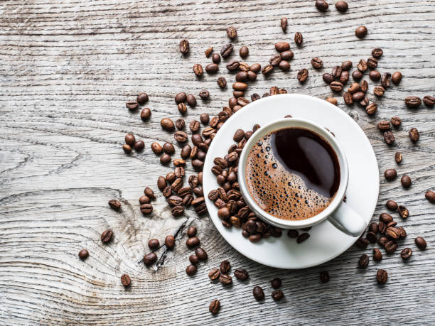 istock Cup of coffee surrounded by coffee beans. 898994894