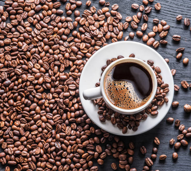 istock Cup of coffee surrounded by coffee beans. 898994988