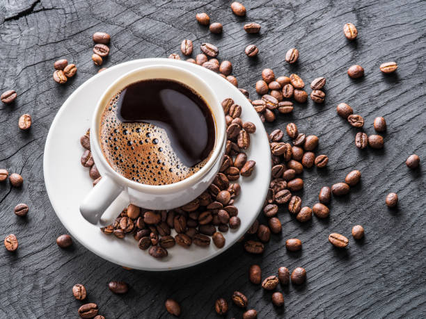 istock Cup of coffee surrounded by coffee beans. 898994990