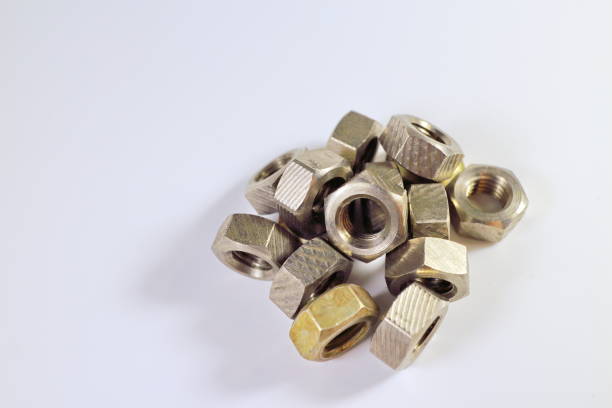 istock shiny silvery yellow metal nuts for bolts on white background 898995038