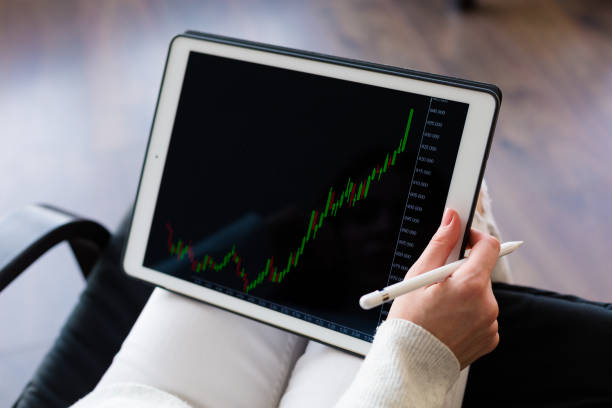 istock Woman holding a tablet with cryptocurrency logos 898995156