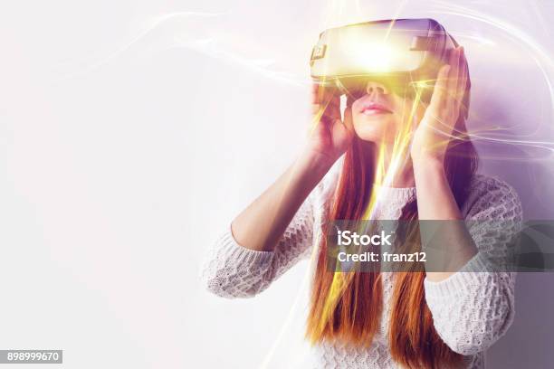 A Young Beautiful Woman In Glasses Of Virtual Reality Saw Something Amazing Modern Technologies Stock Photo - Download Image Now